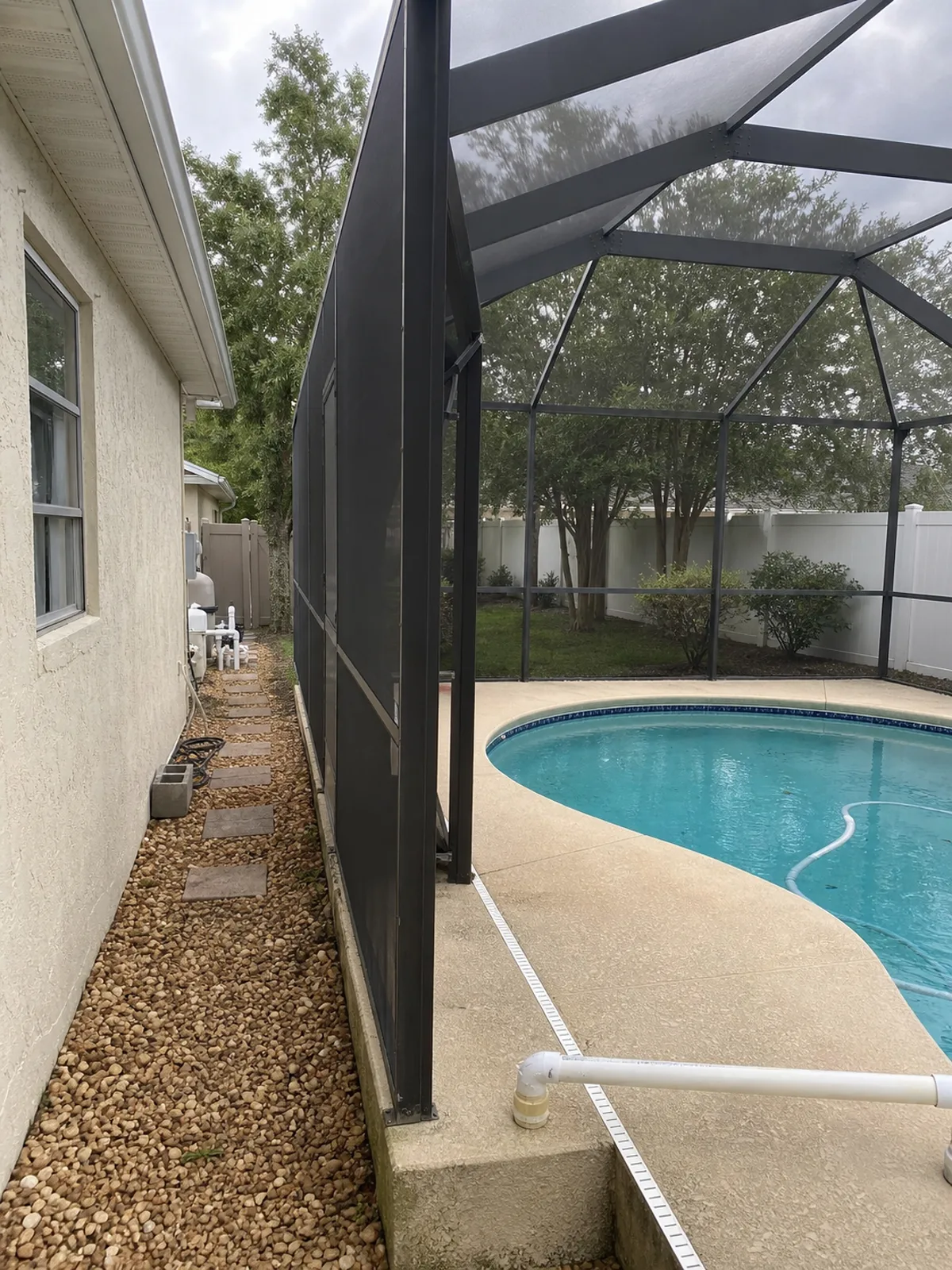 Screen-enclosed Orlando backyard pool showing deck and autofill line, typical of Central Florida homes